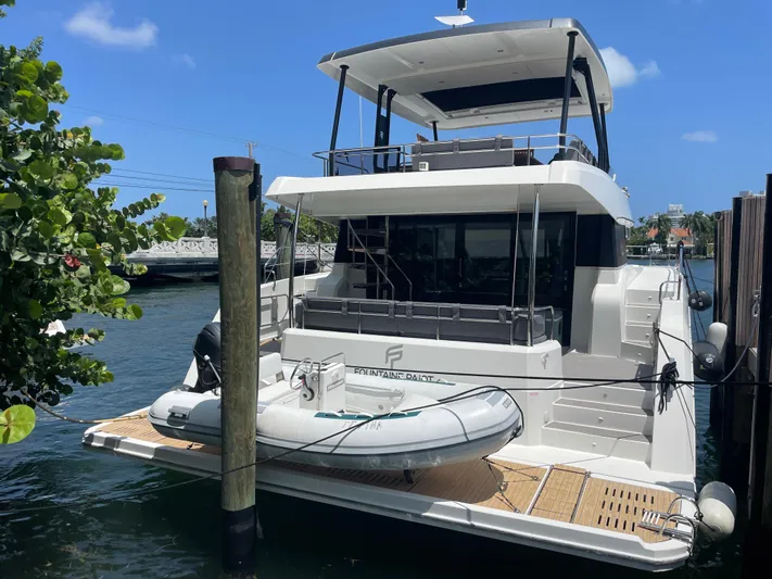 Fina Yacht Photos Pics 2020 Fountaine Pajot MY 44 yacht docked with inflatable boat on deck.