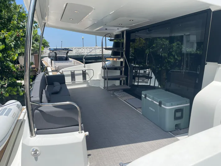 Fina Yacht Photos Pics Spacious deck of 2020 Fountaine Pajot MY 44 yacht with seating and cooler.