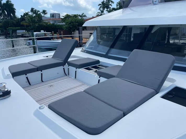 Fina Yacht Photos Pics Luxury sun loungers on 2020 Fountaine Pajot MY 44 yacht deck, docked by waterfront homes.