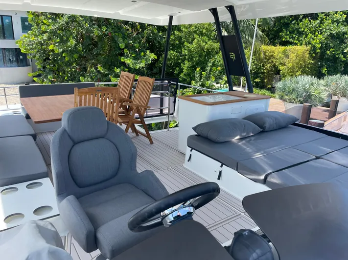 Fina Yacht Photos Pics Luxurious 2020 Fountaine Pajot MY 44 yacht interior with seating, dining area, and lush greenery backdrop.