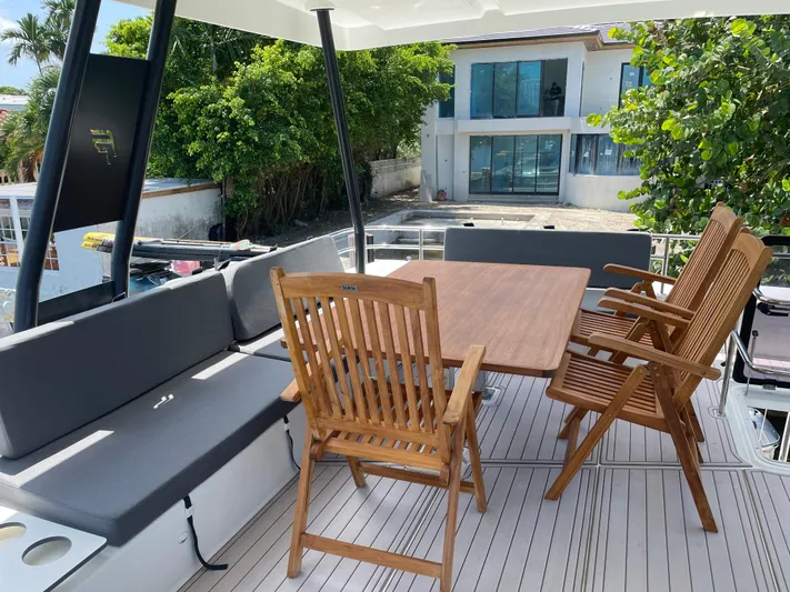 Fina Yacht Photos Pics Fountaine Pajot MY 44 yacht deck with wooden chairs and table, 2020 model.