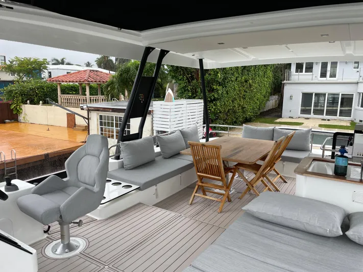 Fina Yacht Photos Pics Spacious deck of 2020 Fountaine Pajot MY 44 yacht with seating and dining area.