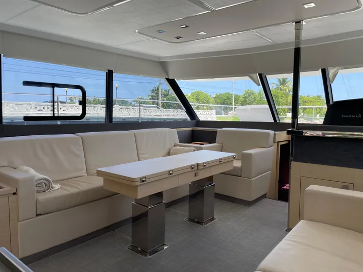Fina Yacht Photos Pics Luxurious interior of 2020 Fountaine Pajot MY 44 yacht with modern seating and table.