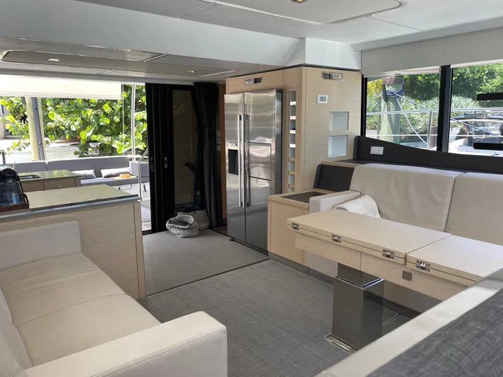 Fina Yacht Photos Pics Luxurious interior of 2020 Fountaine Pajot MY 44 yacht with modern furnishings and large windows.