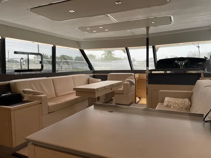 Fina Yacht Photos Pics Luxurious interior of 2020 Fountaine Pajot MY 44 yacht with modern seating and panoramic windows.