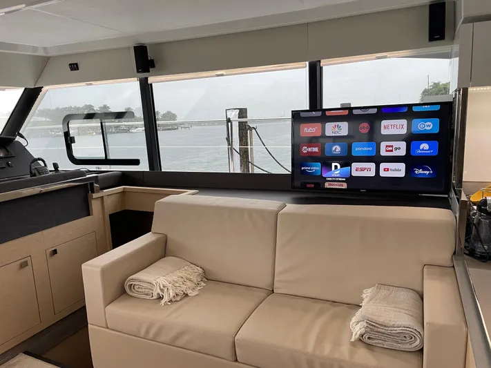 Fina Yacht Photos Pics Interior of 2020 Fountaine Pajot MY 44 yacht with TV and beige seating.