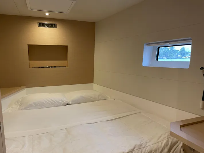 Fina Yacht Photos Pics Cozy bedroom interior of 2020 Fountaine Pajot MY 44 yacht with window view.