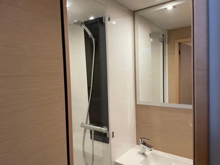 Fina Yacht Photos Pics Modern bathroom interior on 2020 Fountaine Pajot MY 44 yacht, featuring sleek shower and sink.