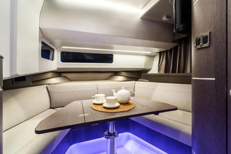  Yacht Photos Pics Manufacturer Provided Image: Interior of 2024 Galeon 325 GTO yacht with cozy seating and tea set.