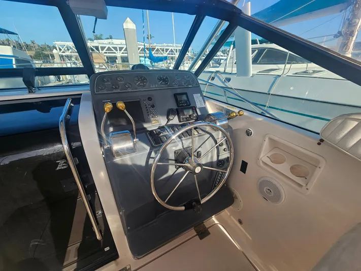 Deep Rapture Yacht Photos Pics 2003 Tiara Yachts 3100 Open LE helm with steering wheel and controls.