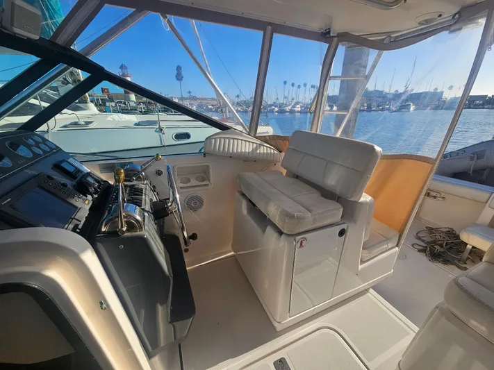 Deep Rapture Yacht Photos Pics 2003 Tiara Yachts 3100 Open LE cockpit with helm, seating, and marina view.