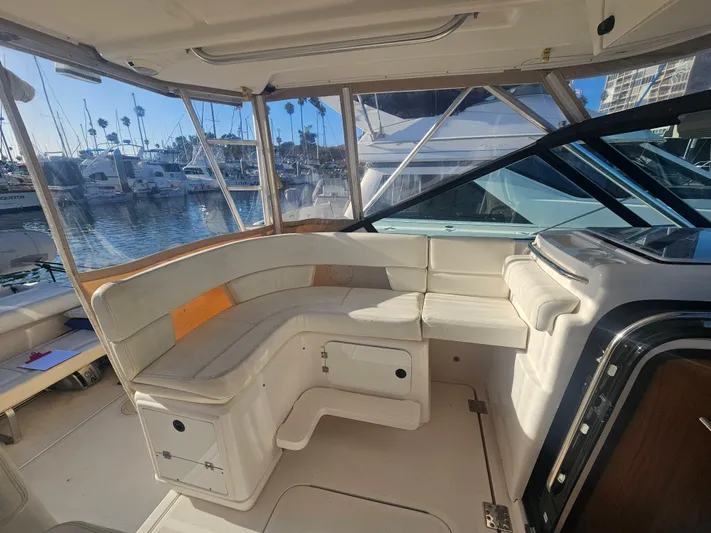 Deep Rapture Yacht Photos Pics 2003 Tiara Yachts 3100 Open LE interior with spacious seating and marina view.