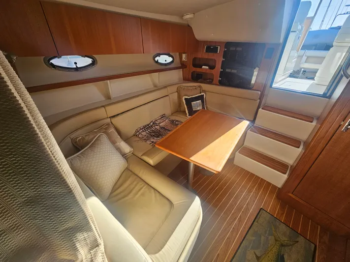 Deep Rapture Yacht Photos Pics 2003 Tiara Yachts 3100 Open LE interior with cozy seating and wooden table.
