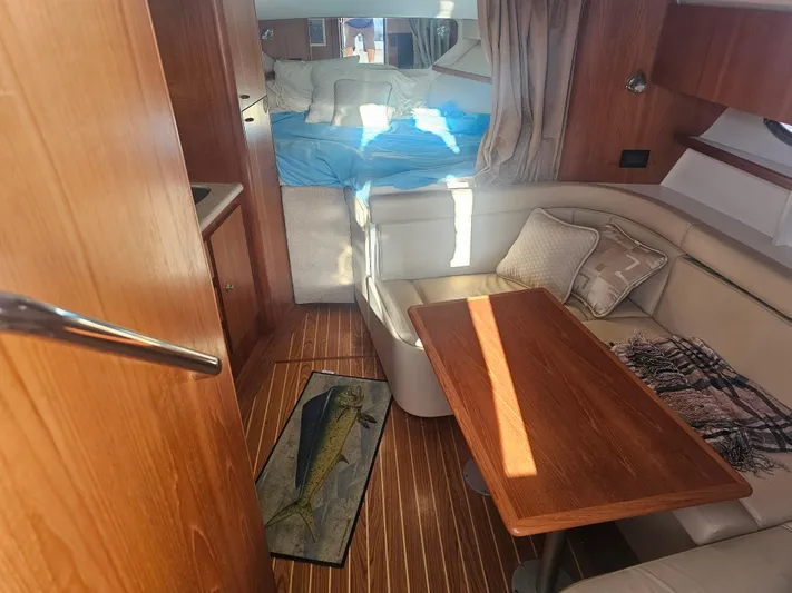 Deep Rapture Yacht Photos Pics 2003 Tiara Yachts 3100 Open LE interior with cozy seating and wooden table.