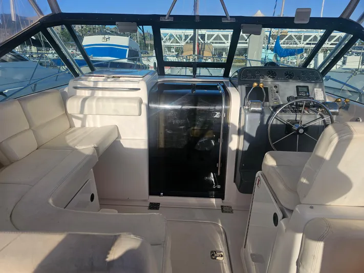 Deep Rapture Yacht Photos Pics 2003 Tiara Yachts 3100 Open LE cockpit with helm, seating, and navigation equipment.