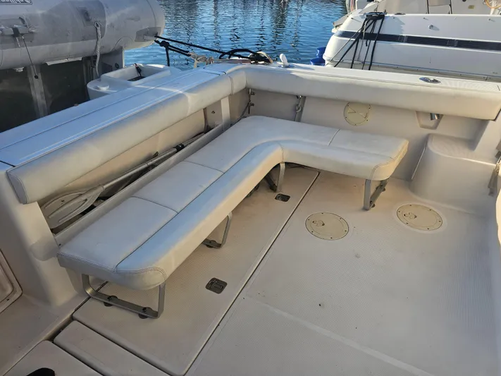 Deep Rapture Yacht Photos Pics 2003 Tiara Yachts 3100 Open LE with white L-shaped seating on deck.