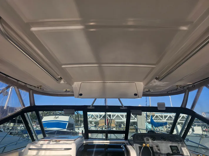 Deep Rapture Yacht Photos Pics 2003 Tiara Yachts 3100 Open LE cockpit view with marina background.