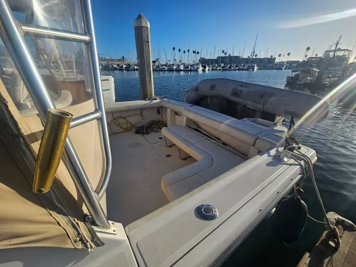 Deep Rapture Yacht Photos Pics 2003 Tiara Yachts 3100 Open LE at marina, showcasing spacious deck and scenic harbor view.