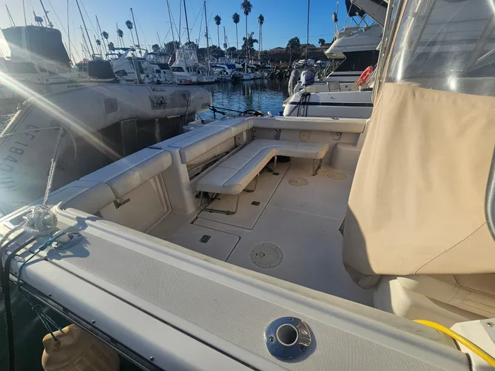 Deep Rapture Yacht Photos Pics 2003 Tiara Yachts 3100 Open LE docked, showcasing spacious deck and seating area.