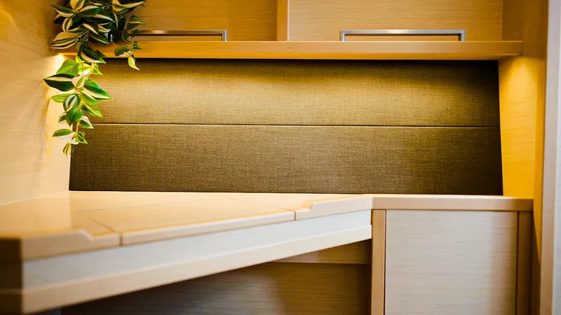 Respite At Sea Yacht Photos Pics Modern interior of Lagoon 560 yacht, 2018 model, featuring sleek wooden cabinetry and ambient lighting.