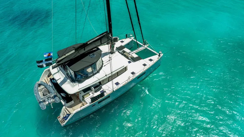Respite At Sea Yacht Photos Pics 2018 Lagoon 560 catamaran sailing on clear turquoise waters.