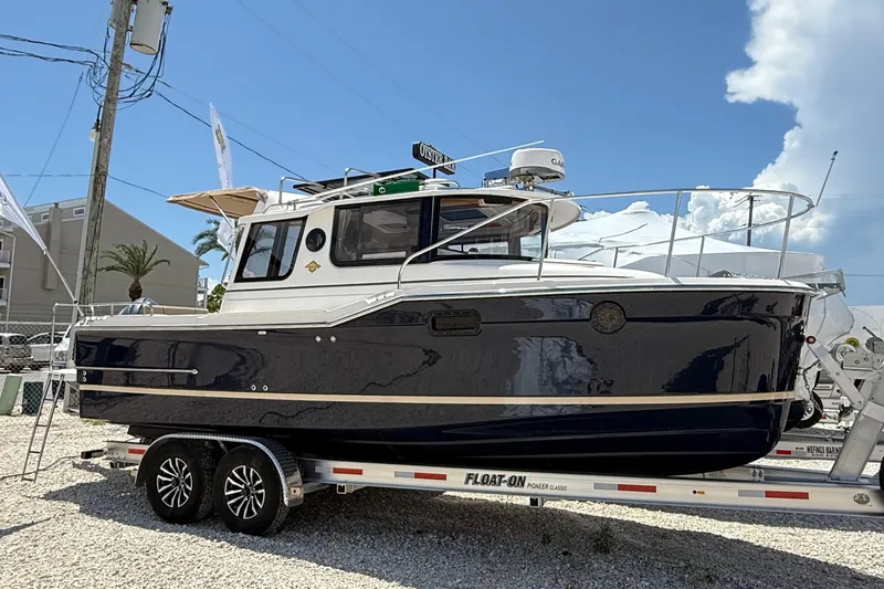  Yacht Photos Pics 2025 Ranger Tugs R-23 boat on trailer under clear blue sky.