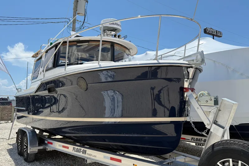  Yacht Photos Pics 2025 Ranger Tugs R-23 boat on trailer under clear blue sky.