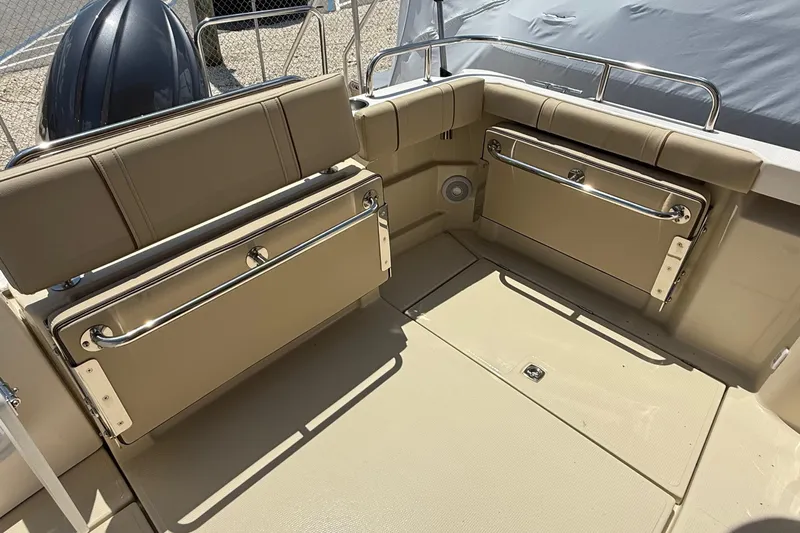  Yacht Photos Pics 2025 Ranger Tugs R-23 boat interior with foldable seating and beige upholstery.