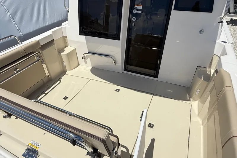  Yacht Photos Pics 2025 Ranger Tugs R-23 boat interior with beige seating and sleek design.