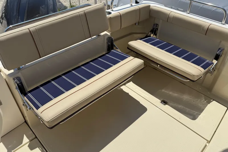  Yacht Photos Pics 2025 Ranger Tugs R-23 boat seating with blue striped cushions and beige upholstery.