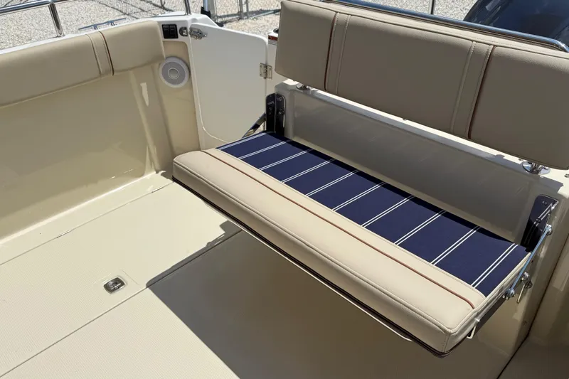  Yacht Photos Pics 2025 Ranger Tugs R-23 boat interior with foldable seating and striped cushion.
