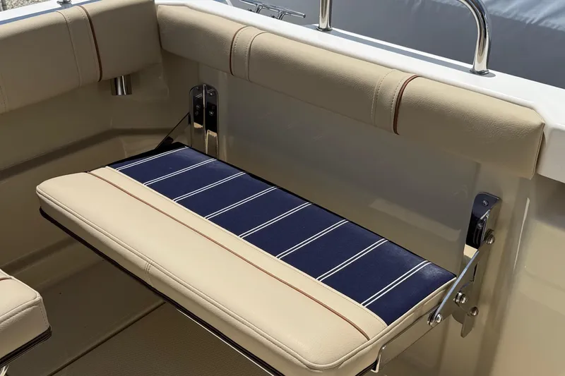  Yacht Photos Pics 2025 Ranger Tugs R-23 boat seat with beige and blue striped upholstery.