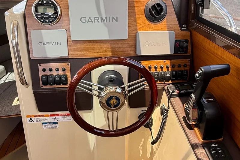  Yacht Photos Pics 2025 Ranger Tugs R-23 helm with Garmin navigation, Yamaha controls, and wood accents.