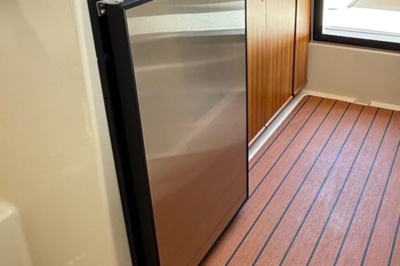  Yacht Photos Pics Interior of 2025 Ranger Tugs R-23 featuring a sleek stainless steel refrigerator.