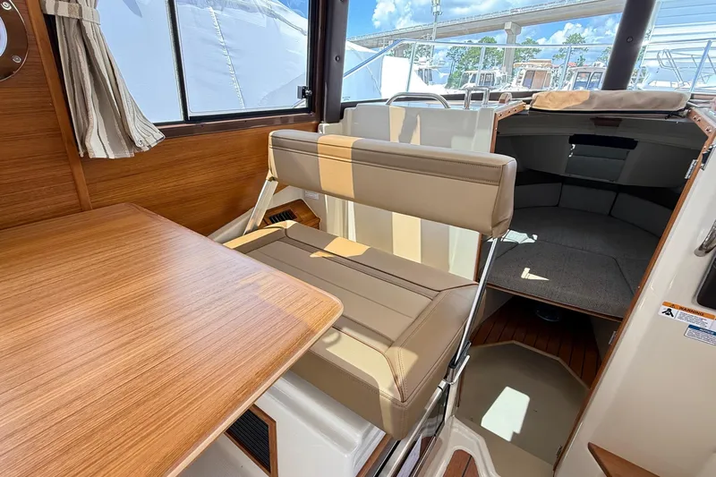  Yacht Photos Pics 2025 Ranger Tugs R-23 interior with seating, table, and cabin view.