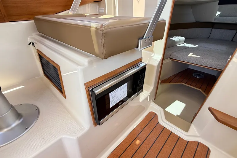  Yacht Photos Pics 2025 Ranger Tugs R-23 interior with microwave, seating, and cabin area.