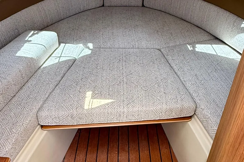  Yacht Photos Pics 2025 Ranger Tugs R-23 interior cabin with patterned cushions and wooden flooring.
