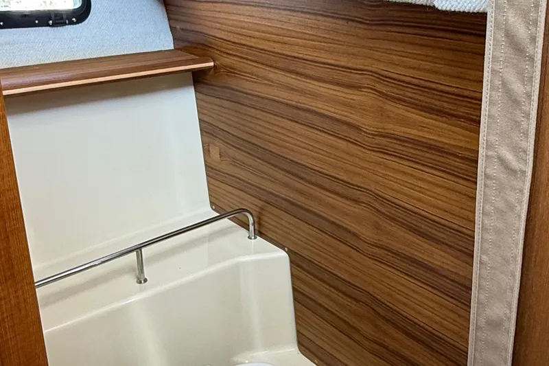  Yacht Photos Pics Interior of 2025 Ranger Tugs R-23 boat with wood paneling and compact design.