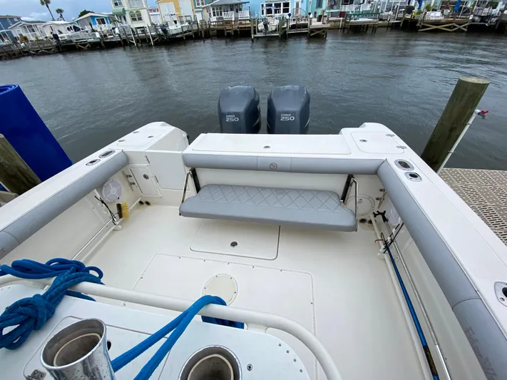  Yacht Photos Pics 2007 Edgewater 318CC boat with twin engines docked by waterfront homes.