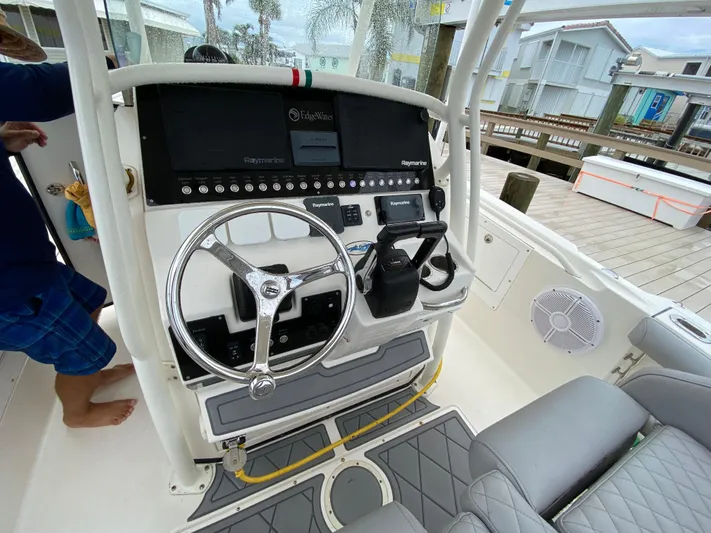  Yacht Photos Pics 2007 Edgewater 318CC boat dashboard with steering wheel and controls, dockside view.