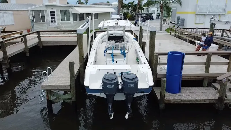  Yacht Photos Pics 2007 Edgewater 318CC boat docked at a marina with dual outboard motors.