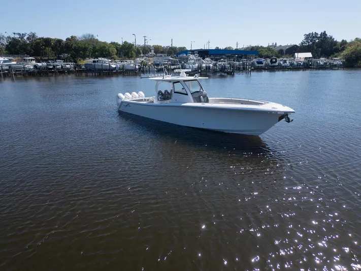 Grey Goose Yacht Photos Pics 2020 Blackwater 43 Sportfish boat on calm water near a marina.