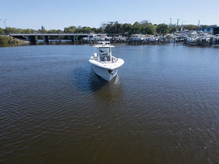 Grey Goose Yacht Photos Pics 2020 Blackwater 43 Sportfish boat on calm water near a marina.