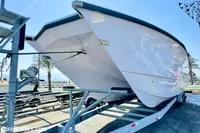 2025 Catamaran 47 Offshore on trailer, sleek design, sunny day, palm trees in background.