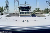2025 Catamaran 47 Offshore, sleek design, docked with palm trees in background.