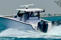 2025 Catamaran 47 Offshore cruising on water, featuring powerful outboard engines.