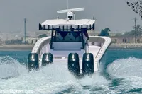 2025 Catamaran 47 Offshore speeding on water, showcasing powerful engines and sleek design.