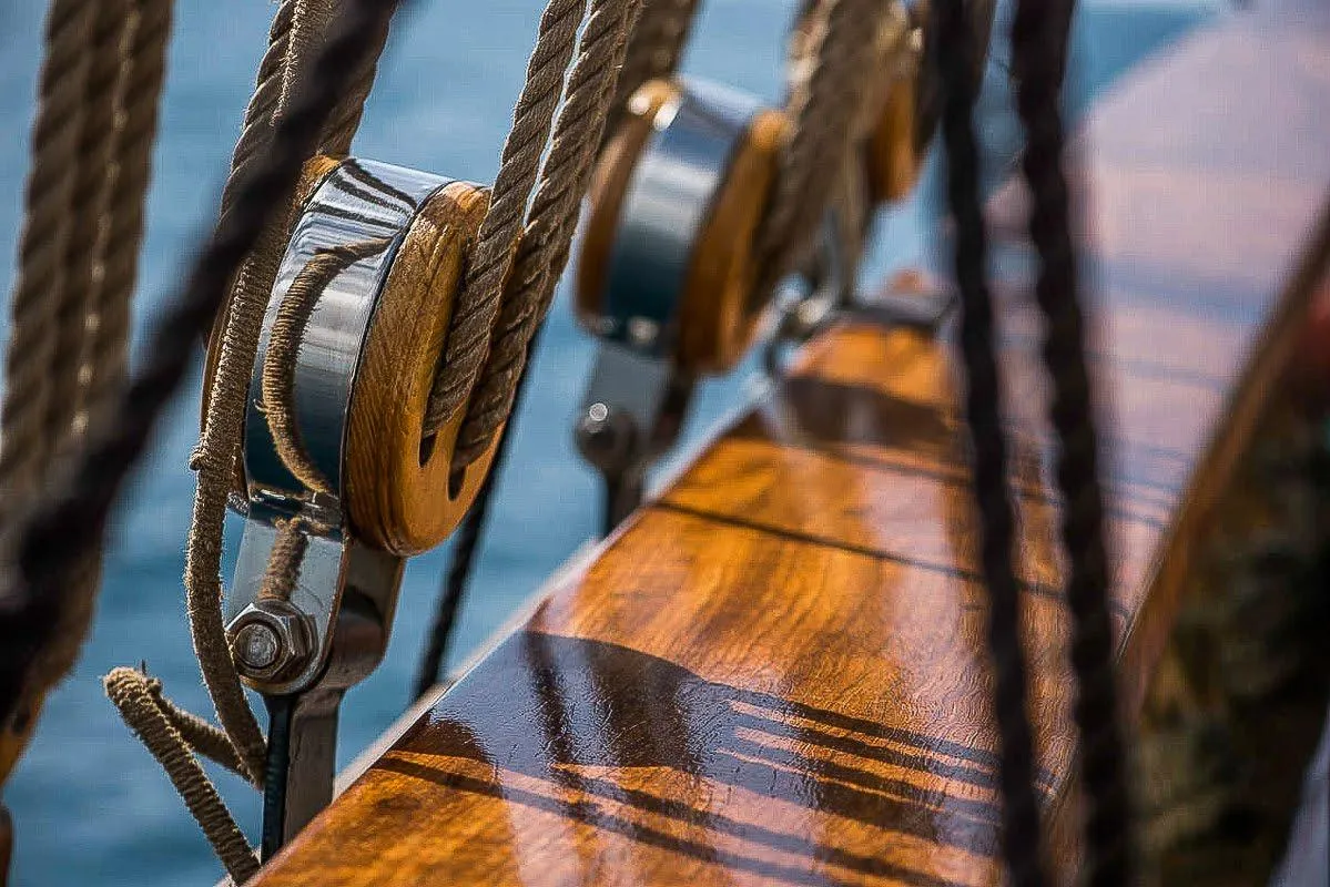 Polished wooden deck with ropes and pulleys on a custom 2004 boat.