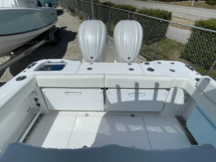 Ice Blue Yacht Photos Pics 2024 Everglades 285CC boat with dual engines, white interior, and storage compartments.