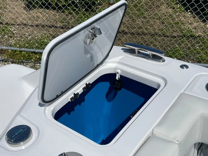 Ice Blue Yacht Photos Pics Open storage compartment on 2024 Everglades 285CC boat, featuring sleek design and blue interior.